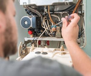 Technician repairing Gas Furnace. Technician repairing Gas Furnace.