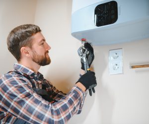 worker set up central gas heating boiler at home worker set up central gas heating boiler at home
